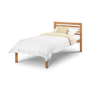 Wooden bed with white bedding and a yellow blanket on a white background
