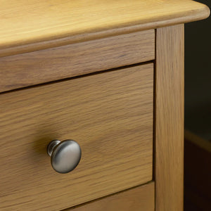 Wooden drawer with a metal handle on a dark background