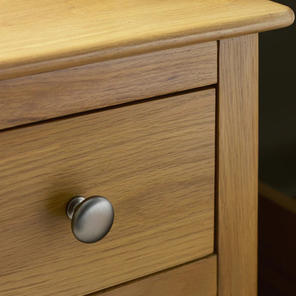 Wooden drawer with a metal handle on a dark background