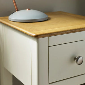Light gray nightstand with wooden top and silver knob