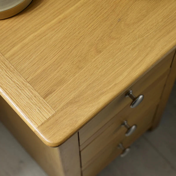 Wooden cabinet with a visible grain pattern and metal handles.