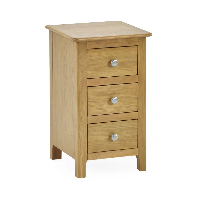 Wooden nightstand with three drawers and silver knobs on a white background