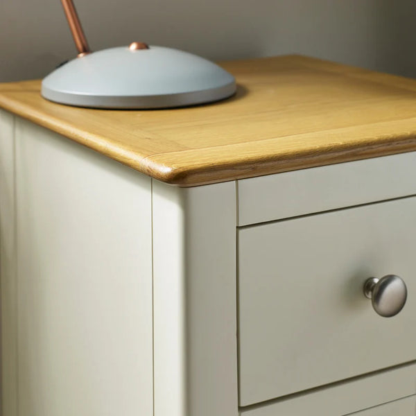 Wooden cabinet with a light gray top and a drawer with a silver handle.