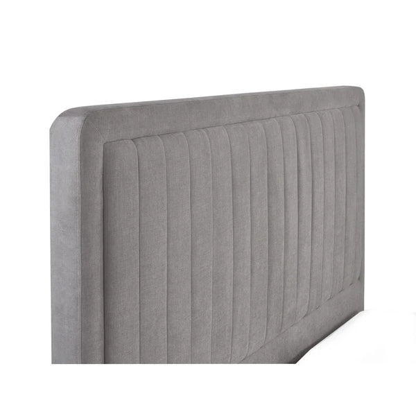 Gray upholstered headboard with a ribbed texture on a white background