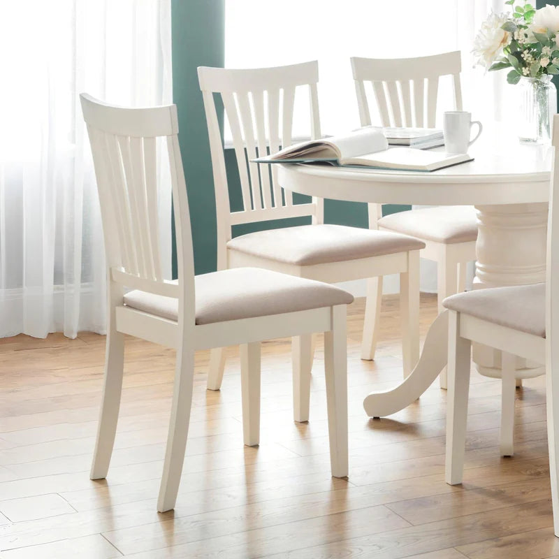 Two white chairs with beige seats on a white background