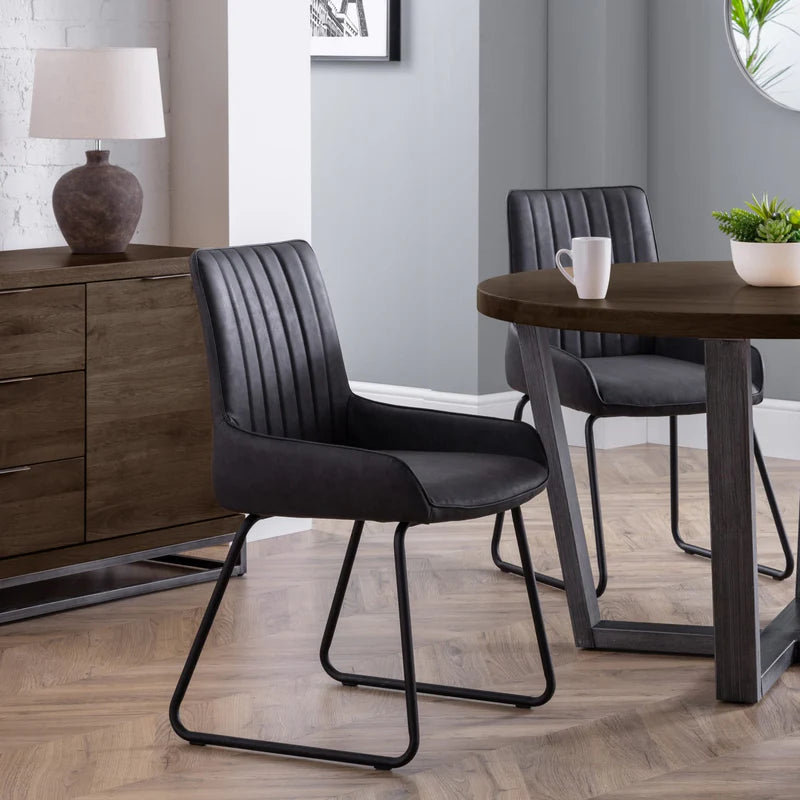 Two grey chairs with metal legs on a white background