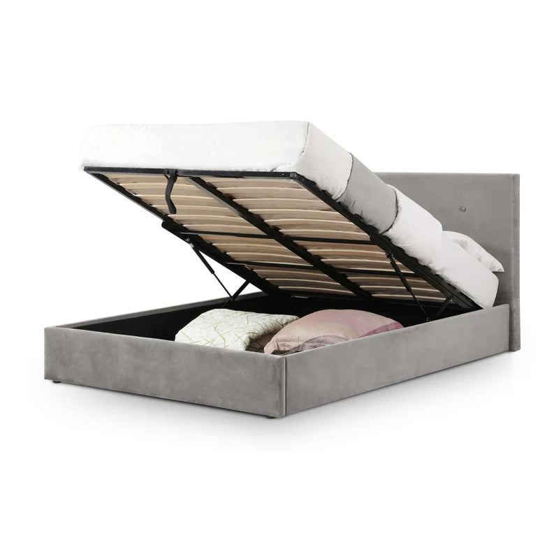 Gray upholstered bed with open storage compartment on a white background