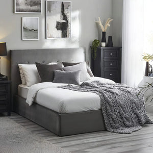 Modern bedroom with gray upholstered bed, nightstands, and abstract art on the wall.