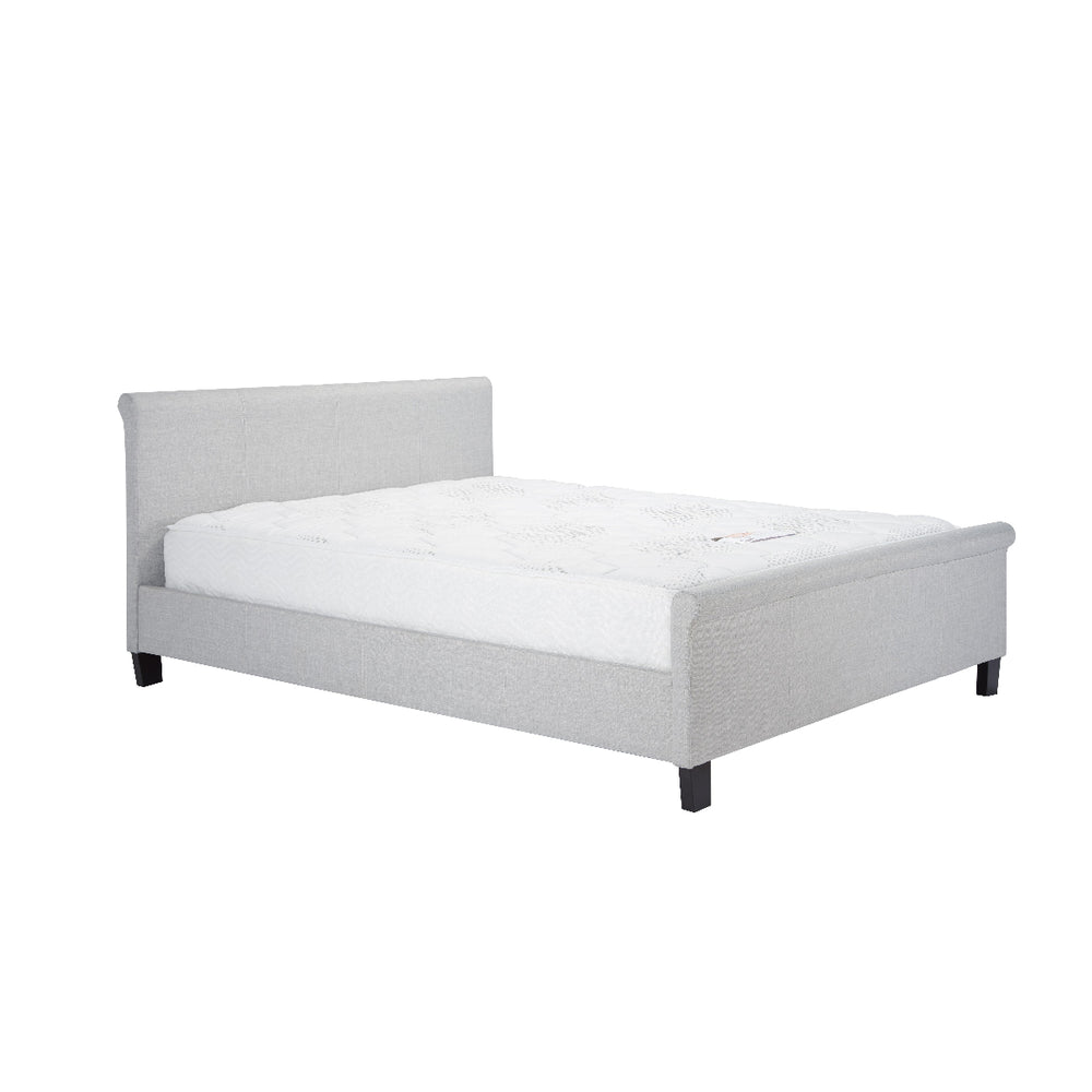 Gray upholstered bed with white mattress on a white background