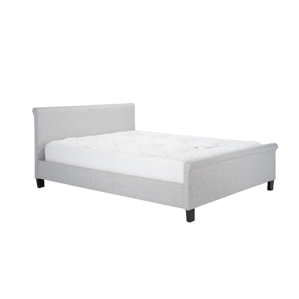 Gray upholstered bed with white mattress on a white background