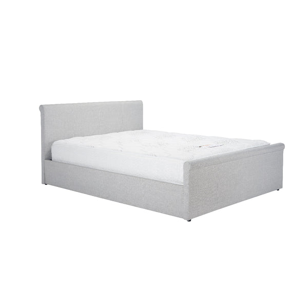 Gray upholstered bed with white mattress on a white background