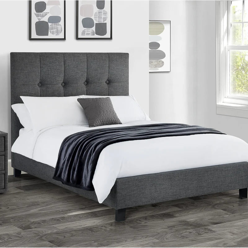 Gray upholstered bed with white mattress on a white background