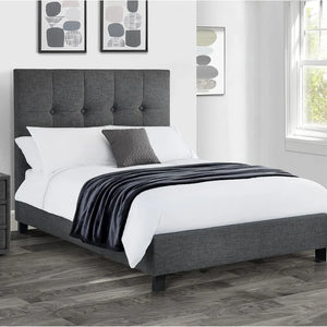 Gray upholstered bed with white bedding and gray blanket in a bedroom setting.