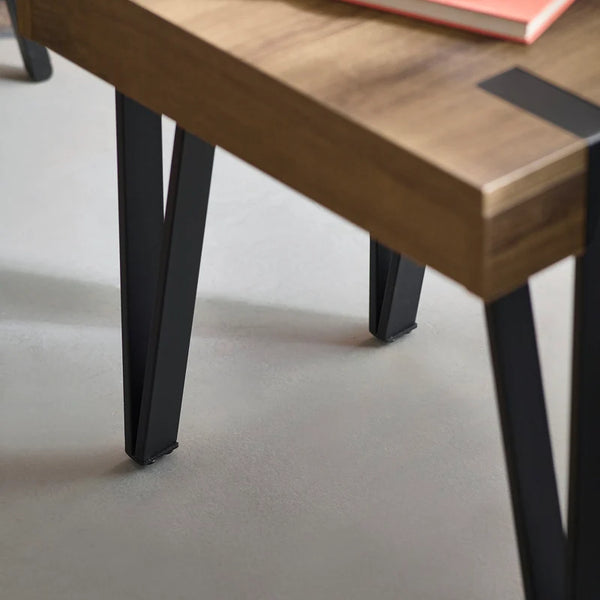 Wooden table with black metal legs on a neutral background