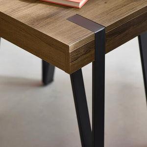 Wooden table with black metal legs on a neutral background