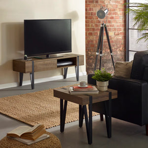 Modern living room with a TV stand, sofa, and decorative items.