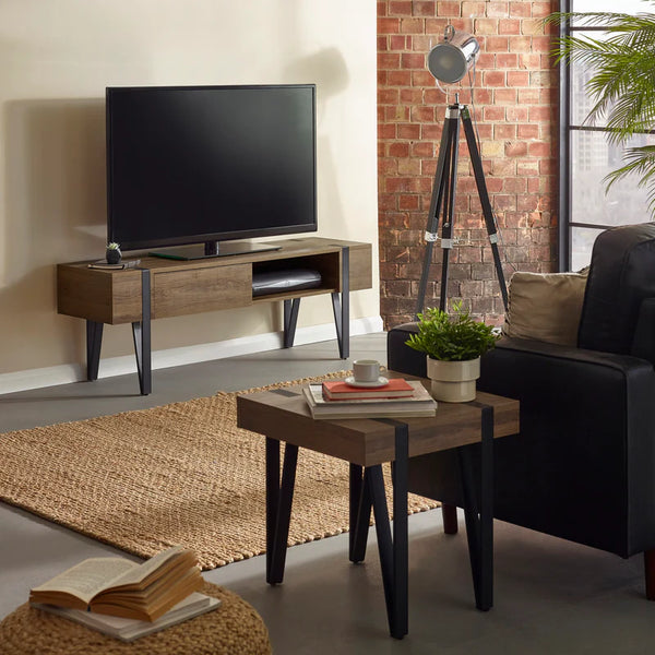 Modern living room with a TV stand, sofa, and decorative items.