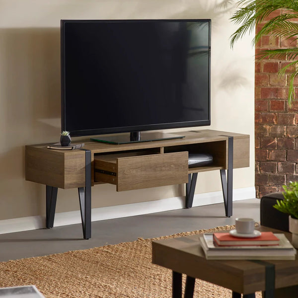 Wooden TV stand with a television mounted on it in a living room setting.