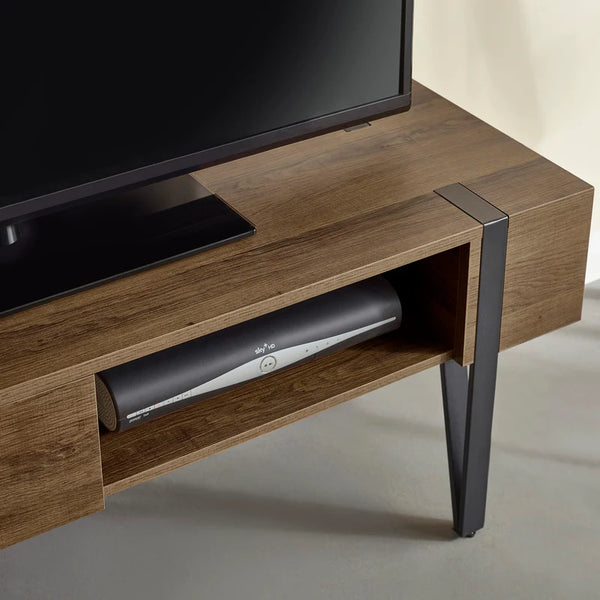Wooden TV stand with a television and soundbar on a neutral background