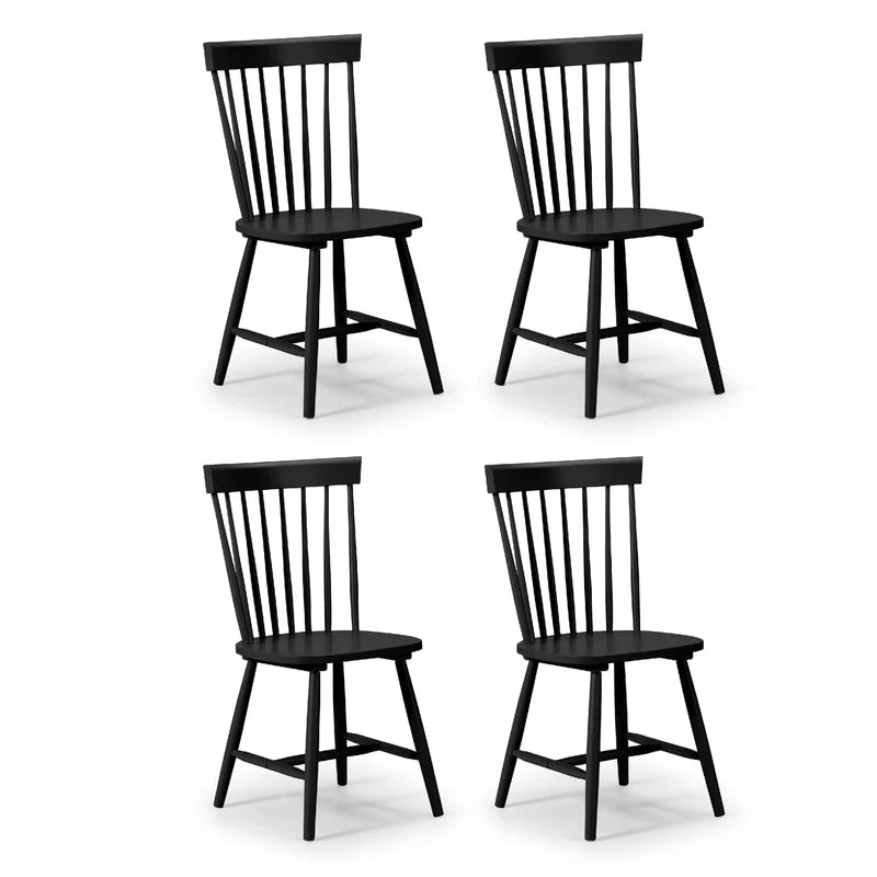 Four black dining chairs with slatted backrests on a white background