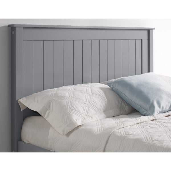 Gray wooden headboard with white bedding and a blue pillow.