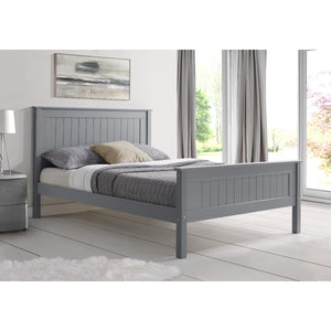 Gray wooden bed in a bedroom with a lamp and window.