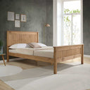 Wooden bed in a room with a window and decor