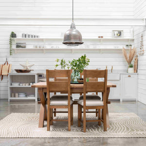 Dining area with wooden table and chairs in a modern kitchen.
