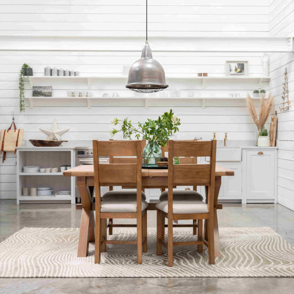 Dining area with wooden table and chairs in a modern kitchen.