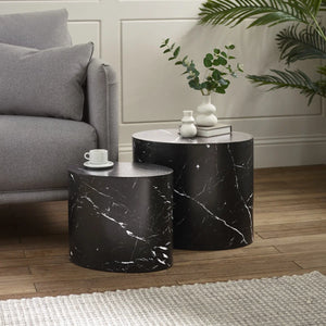 Black marble side tables in a living room setting with a gray sofa and decorative items.