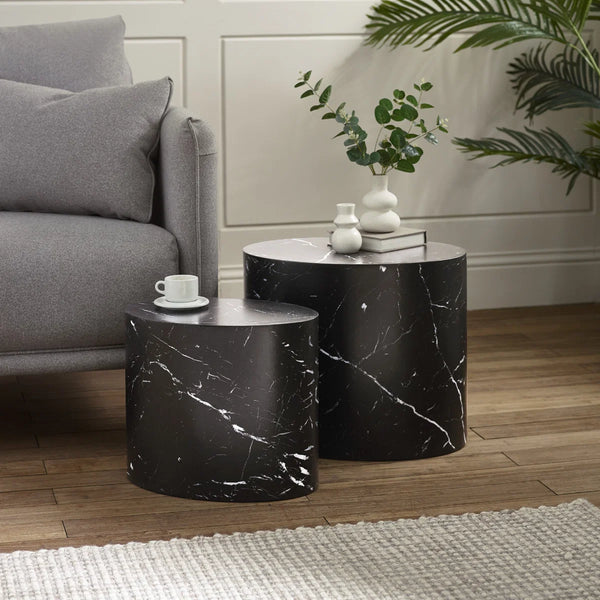 Black marble side tables in a living room setting with a gray sofa and decorative items.