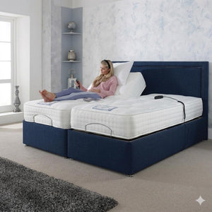Woman lying on a bed with a blue frame and white mattress in a bedroom.