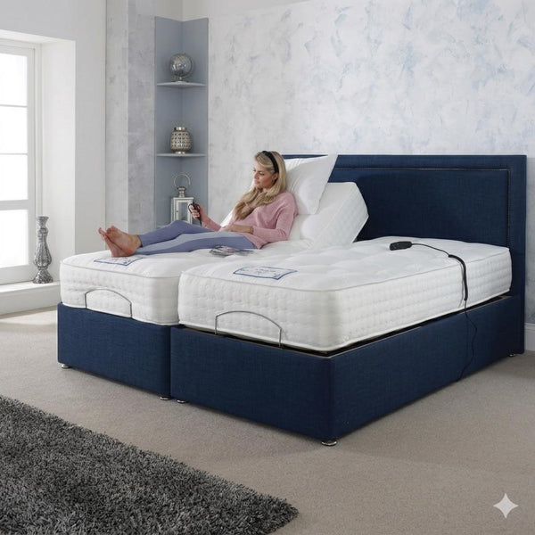 Woman lying on a bed with a blue frame and white mattress in a bedroom.