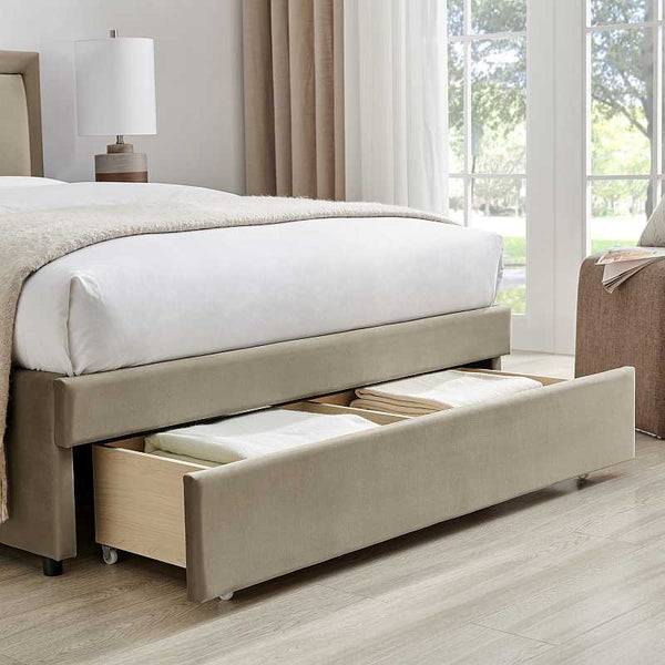 Beige upholstered bed with open drawer in a bedroom setting