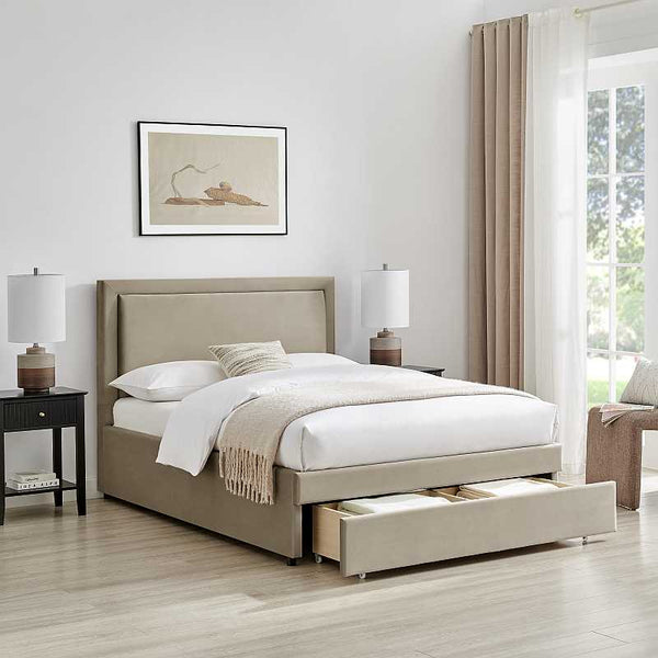 Beige upholstered bed with storage drawers in a bedroom setting.