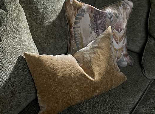 Two pillows on a textured gray sofa