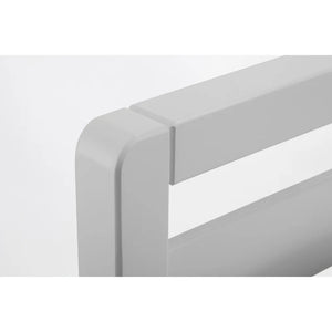 Close-up of a white rectangular object with a smooth surface on a light gray background