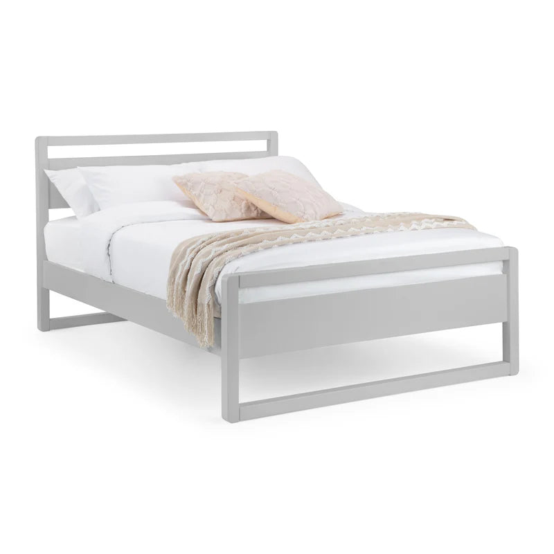White metal bed frame with bedding on a white background