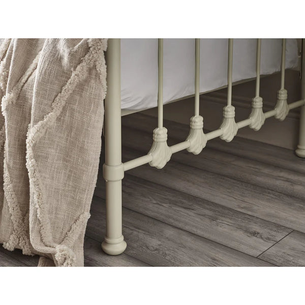 Close-up of a metal bed frame with wooden flooring
