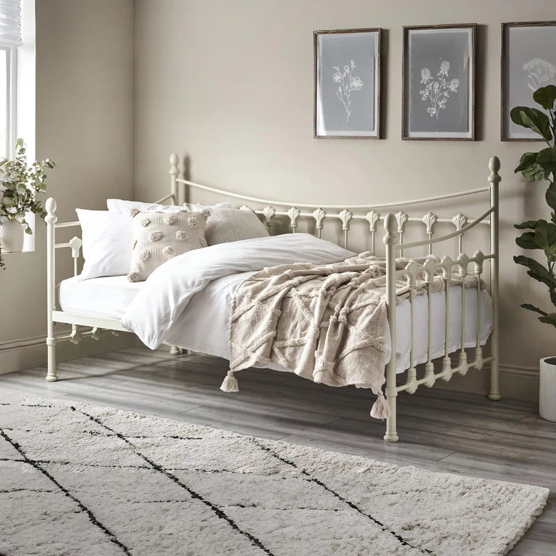 White metal bed frame with a mattress on a white background
