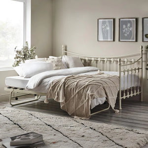 Neatly made bed in a bedroom with decorative elements