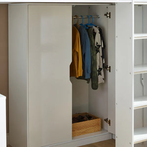 Open wardrobe with clothes hanging inside