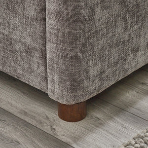 Grey chenille bed frame with wooden legs on a wooden floor