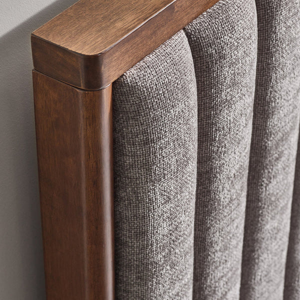 Close-up of a wooden frame and gray textured fabric