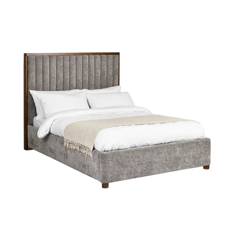 Gray upholstered bed with white bedding on a white background