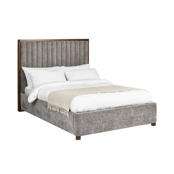 Gray upholstered bed with white bedding on a white background