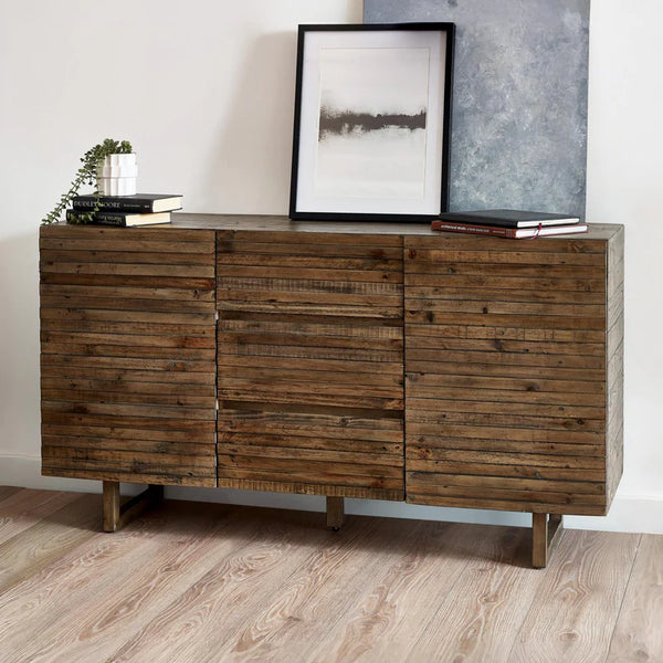Wooden sideboard with books and a framed picture in a room.