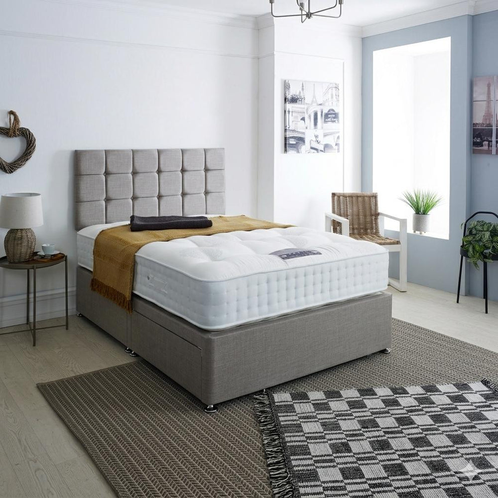 Gray upholstered bed with white mattress on a white background