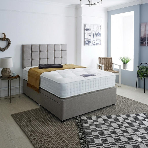 Bedroom with a gray upholstered bed and white mattress