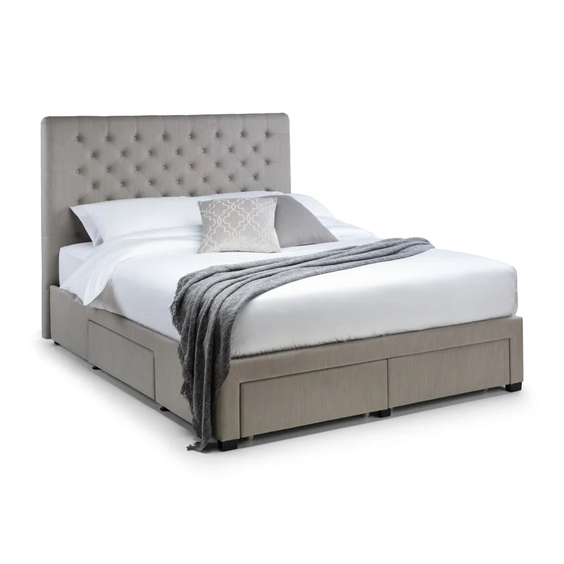 Gray upholstered bed with white bedding and a gray throw blanket on a white background